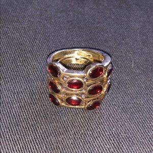 Gold tone ring with red stones.
